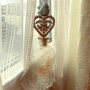 Decorative glass bottle with blue bird